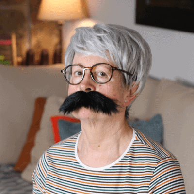 Mature woman wearing a fake mustache
