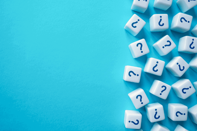 cubs of dice with question marks against a blue background