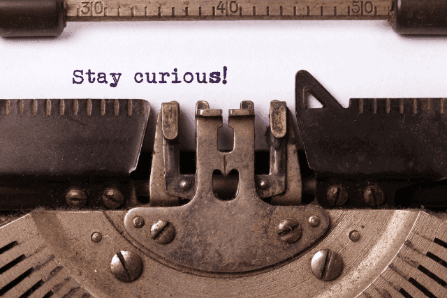 stay curious typed message in typewriter