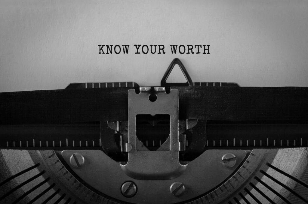 Know Your Worth motivational quote on a vintage typewriter, inspiring self-awareness and confidence.