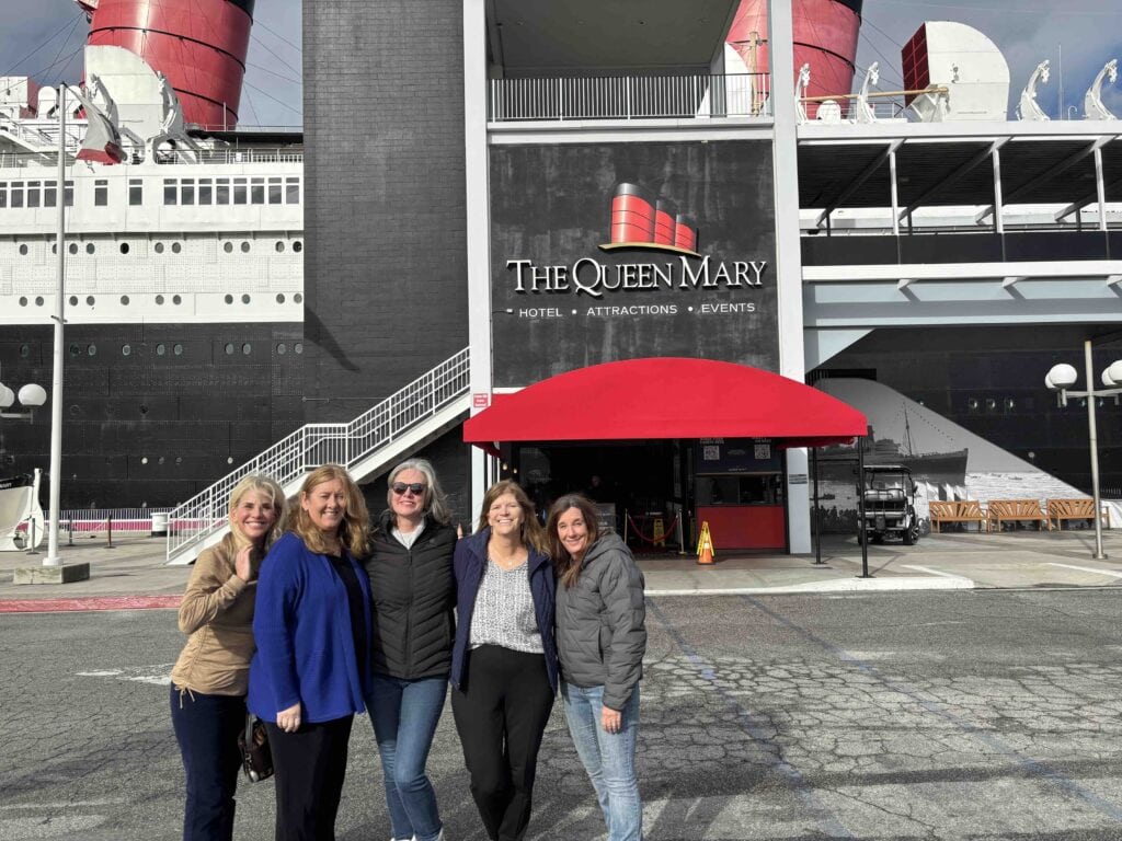 A group of female friends gather outside the main entrance of the Queen Mary in Long Beach
